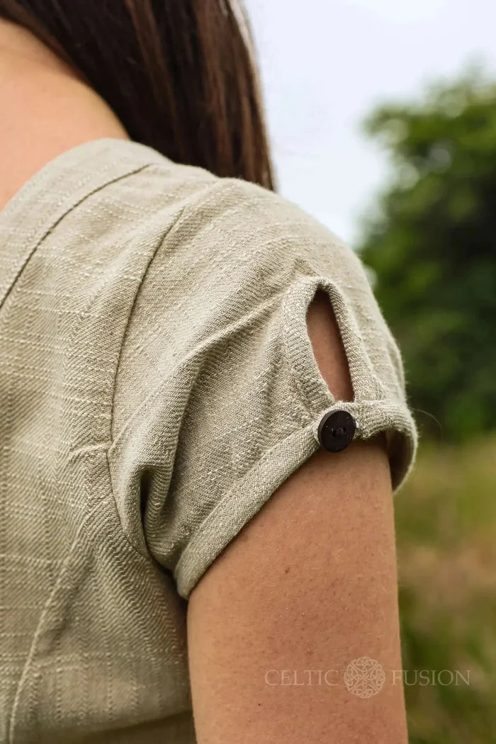 Detail of cap sleeve on beige natural fibre folk summer dress with button tab finish, cottagecore folklore dress design