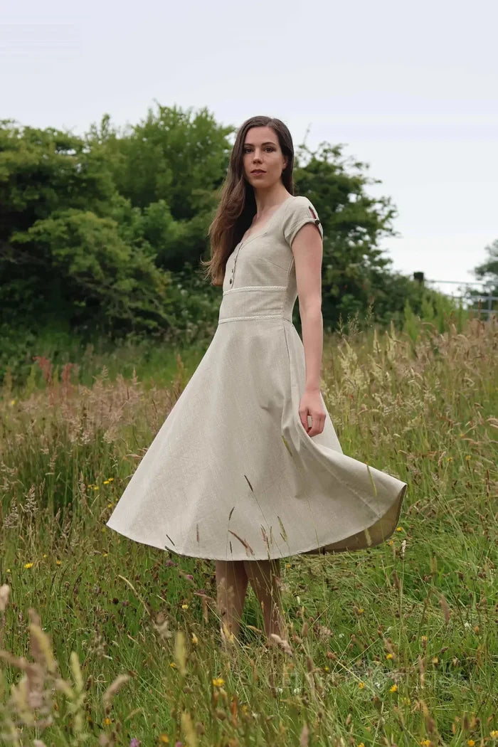 Beige folklore dress with square neck and full twirling skirt, natural fibre midi dress styled in a grassy field