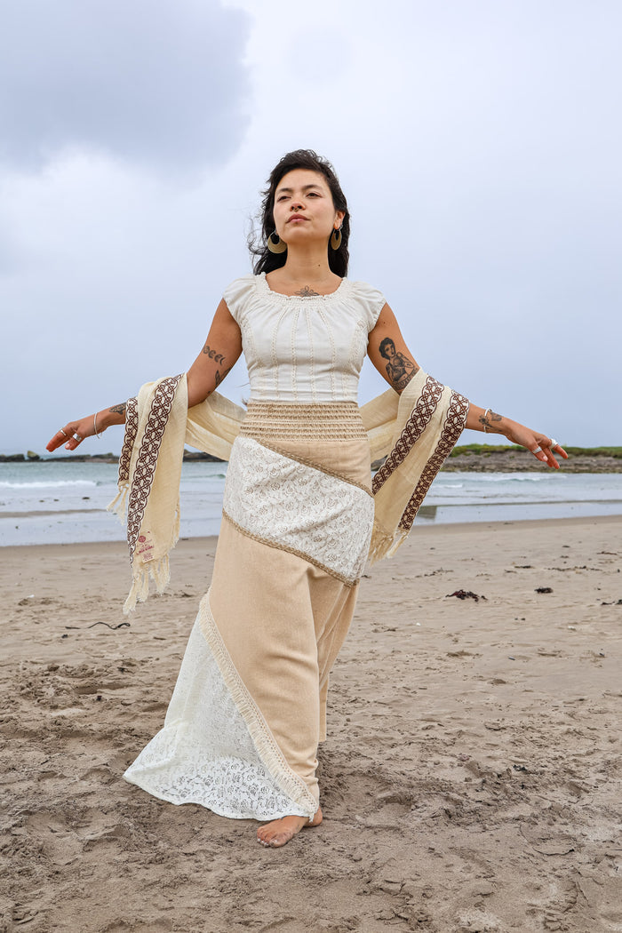 Natural fibre patchwork maxi boho skirt in cotton lace and jute worn on the beach with embroidered shawl