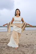Natural fibre patchwork maxi boho skirt in cotton lace and jute worn on the beach with embroidered shawl