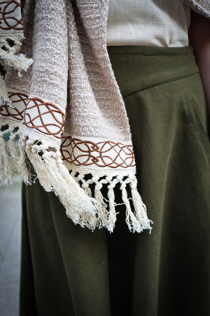 Fringed cotton stole in natural oatmeal tone with Celtic pattern detail and artisan texture