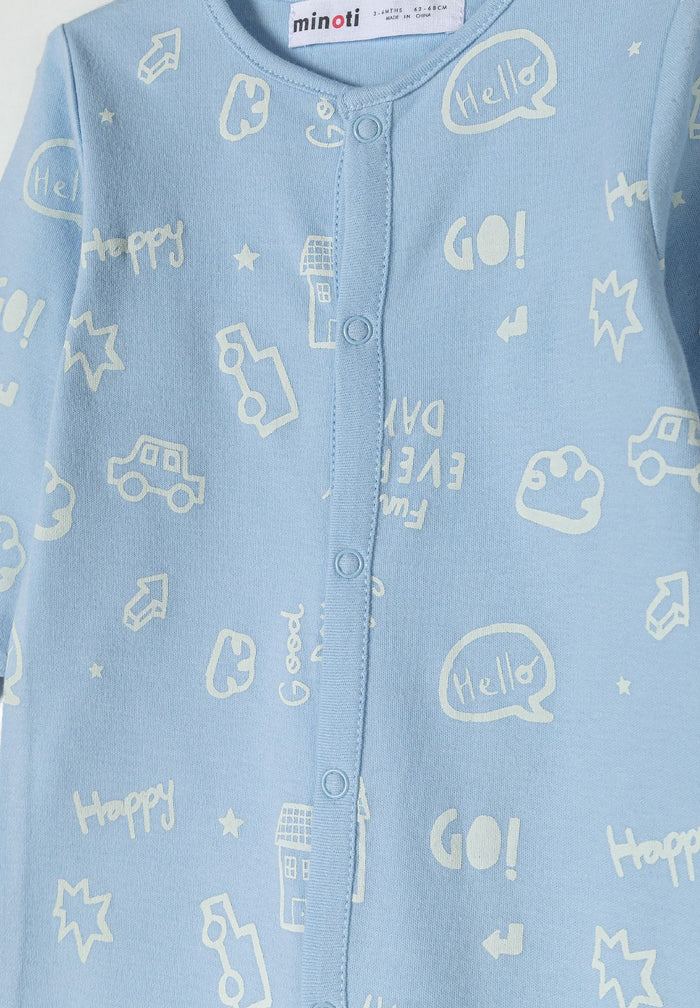 Detail of a boys' sleepsuit in light blue with printed patterns and press studs.