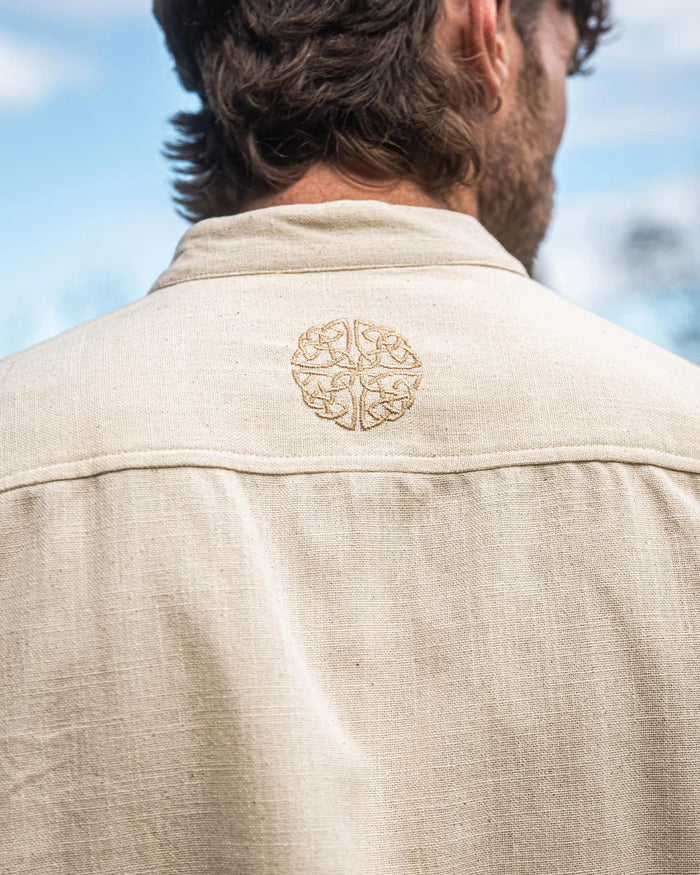 Close-up of Celtic Shield symbol embroidery on an Irish Shirt, showing shield motif on the shoulder of this collarless cotton men’s shirt