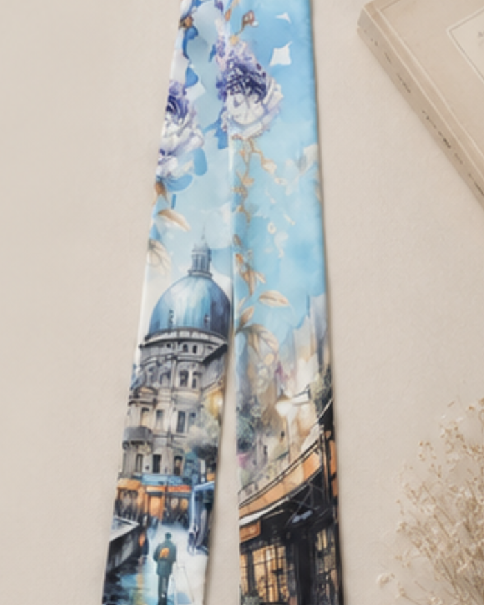 Tie with a scenic design of a building and people on a light blue background