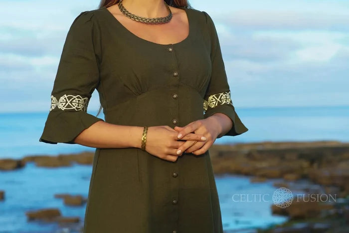 Green Celtic dress close up, button front cotton slub dress with Celtic embroidery on sleeves and flattering waist seam