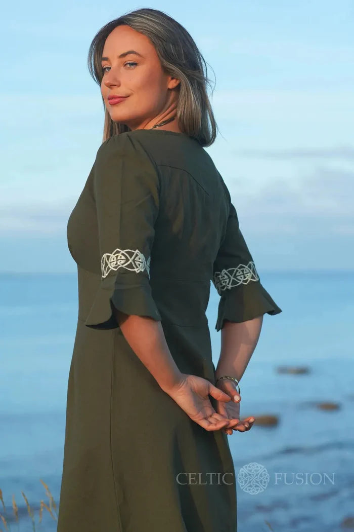Moss green cotton slub dress with Celtic embroidered sleeves, elegant folklore style dress photographed by the sea