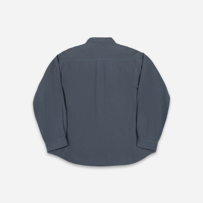 A dark slate blue long-sleeve button-up shirt shown from the back, laid flat against a light gray background.