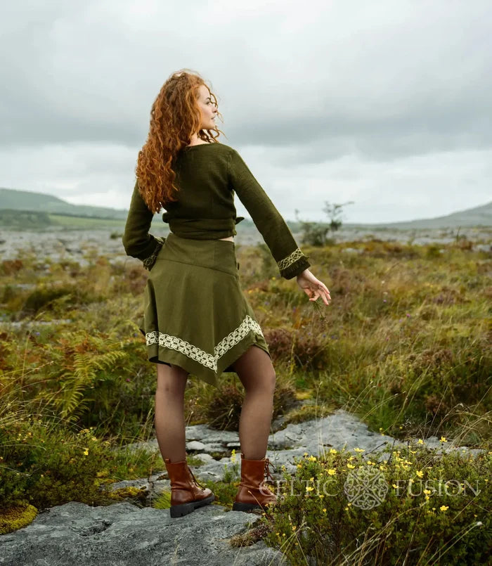 Elva olive green wrap top showing the cropped fit, long sleeves and wrap ties secured around the waist.