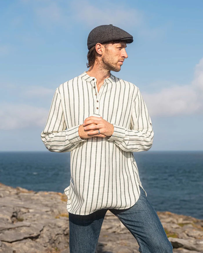 Irish clothing for men and Men’s Irish shirts by Celtic Fusion Design, striped collarless shirt styled with flat cap beside a lighthouse in Ireland