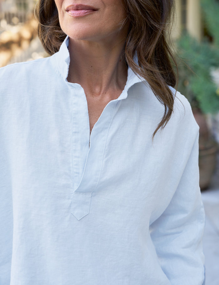 Woman wearing a light blue shirt with a blurred background