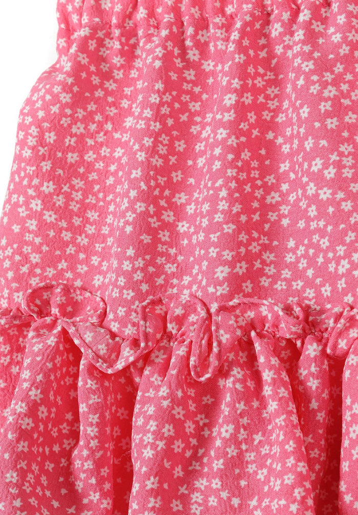Detail of a pink girls skirt with crinkle layered pleats and frills.