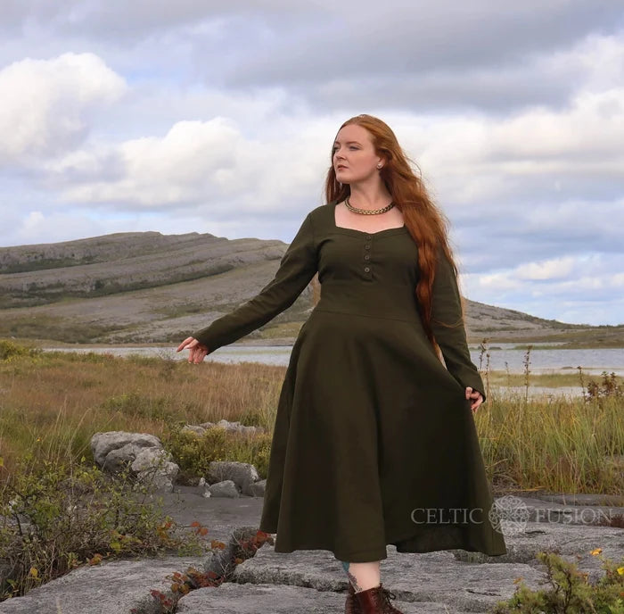 Dark green Imbas Corset Dress in the Burren landscape shot on an Irish girl, long sleeve folklore midi dress with square neckline and flowing skirt