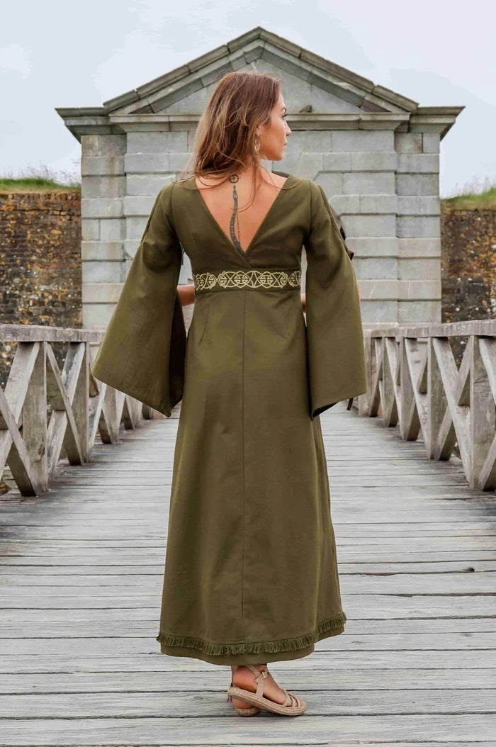 Back view of the Maeve Celtic Dress, green Celtic maxi dress with flowing bell sleeves, deep V back and embroidered Celtic waist detail.