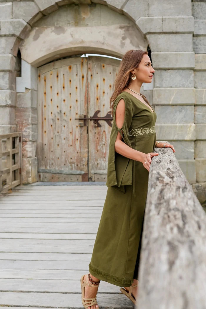 Profile view of Maeve Celtic Dress, green handfasting dress with bell sleeves, Celtic knot embroidered waist and full length skirt.