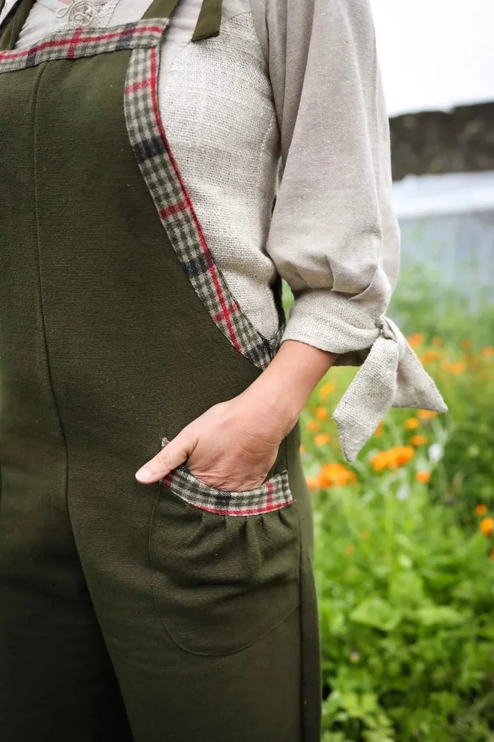 Close-up of green overalls with plaid tweed pocket trim and practical side pocket detail designed by Celtic Fusion