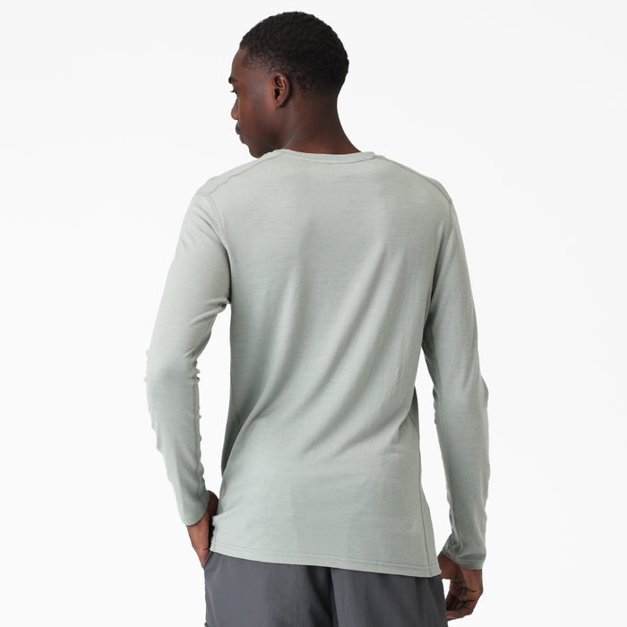 Man wearing a light green long-sleeve Merino shirt on a white background