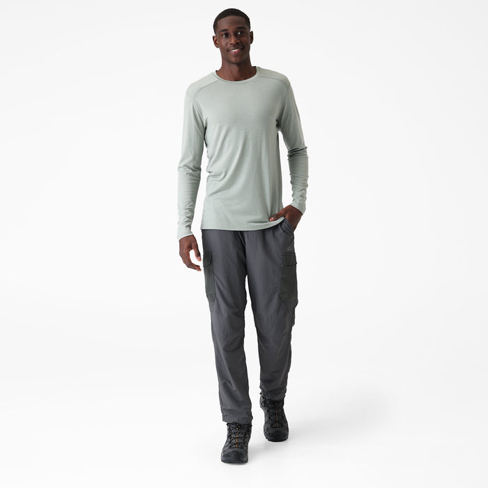 Man wearing a light green long-sleeve Merino shirt on a white background