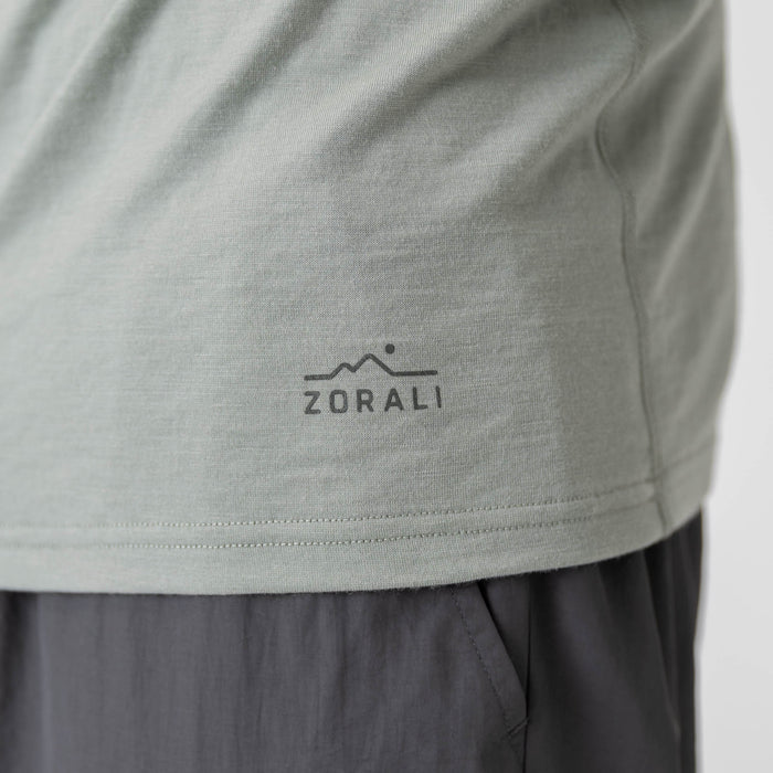 Man wearing a light green long-sleeve Merino shirt on a white background