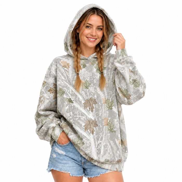 Back view of the printed pullover hoodie on a woman, showing the hood and mixed-color leaf print against a white background.