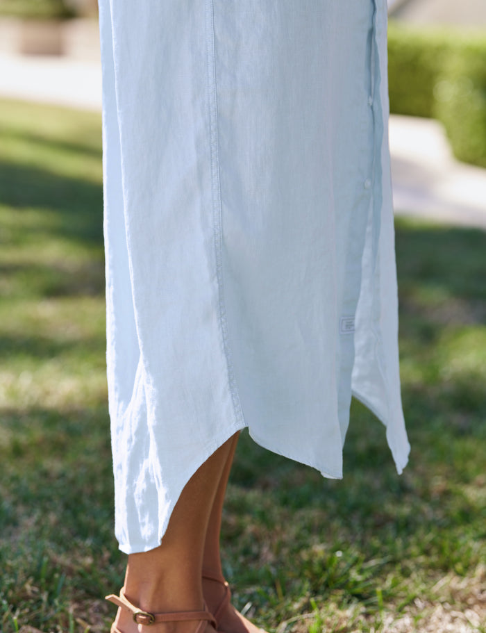 Light blue dress with a blurred background of green grass