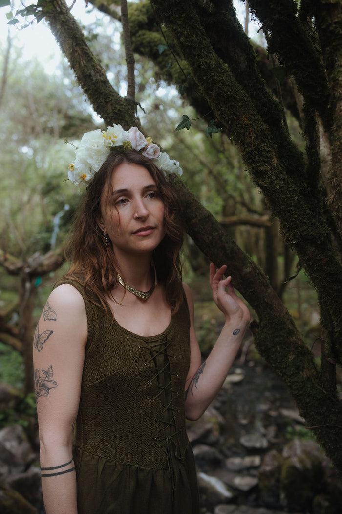 Close-up of Rosemary Green Corset Dress by Celtic Fusion showing lace-up bodice, folklore dress details in woodland setting