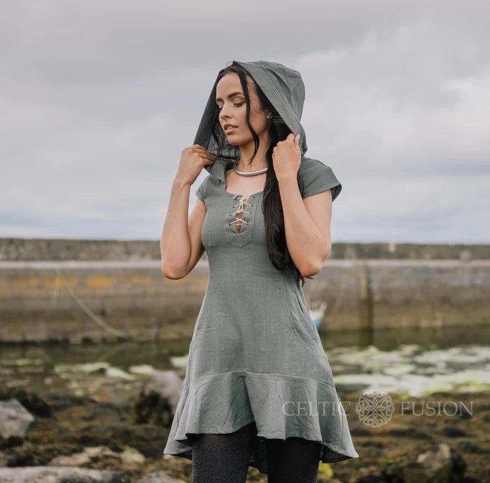 Slate blue hooded corset dress with lace-up neckline, curved pockets and a softly flared dipped hem.