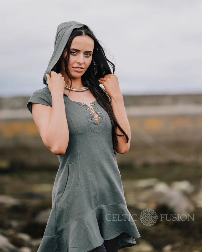 Natural cotton folklore dress in slate blue, showing the hood, fitted bodice and contrasting lace-up neckline.