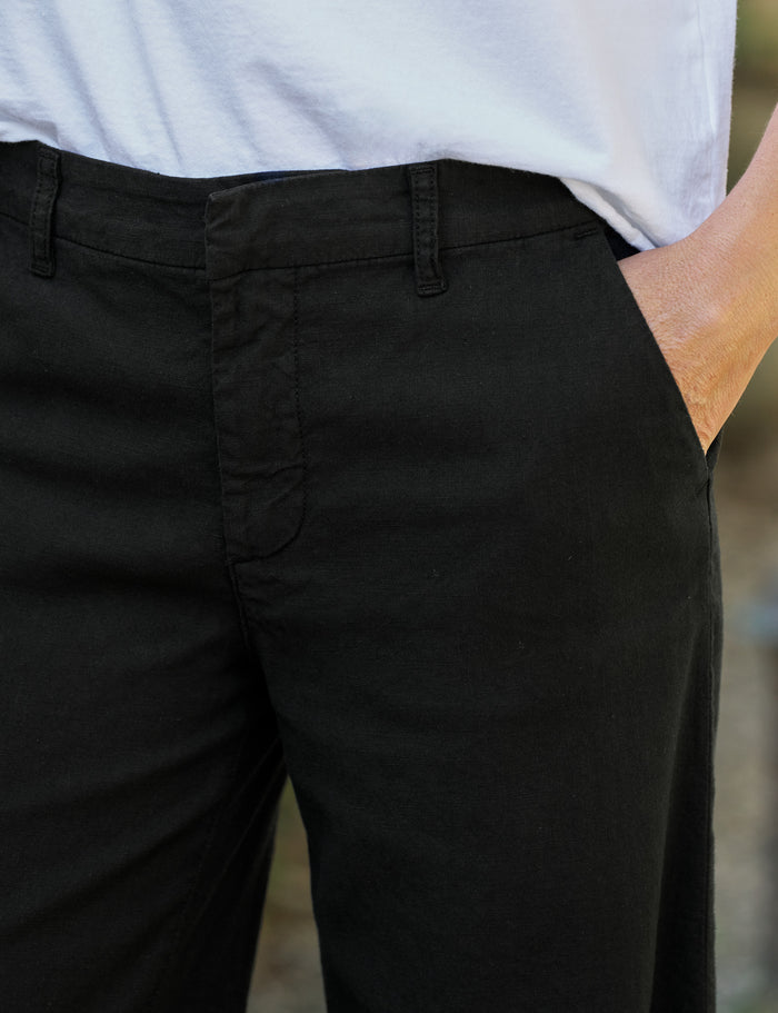 Person wearing black pants with a blurred background